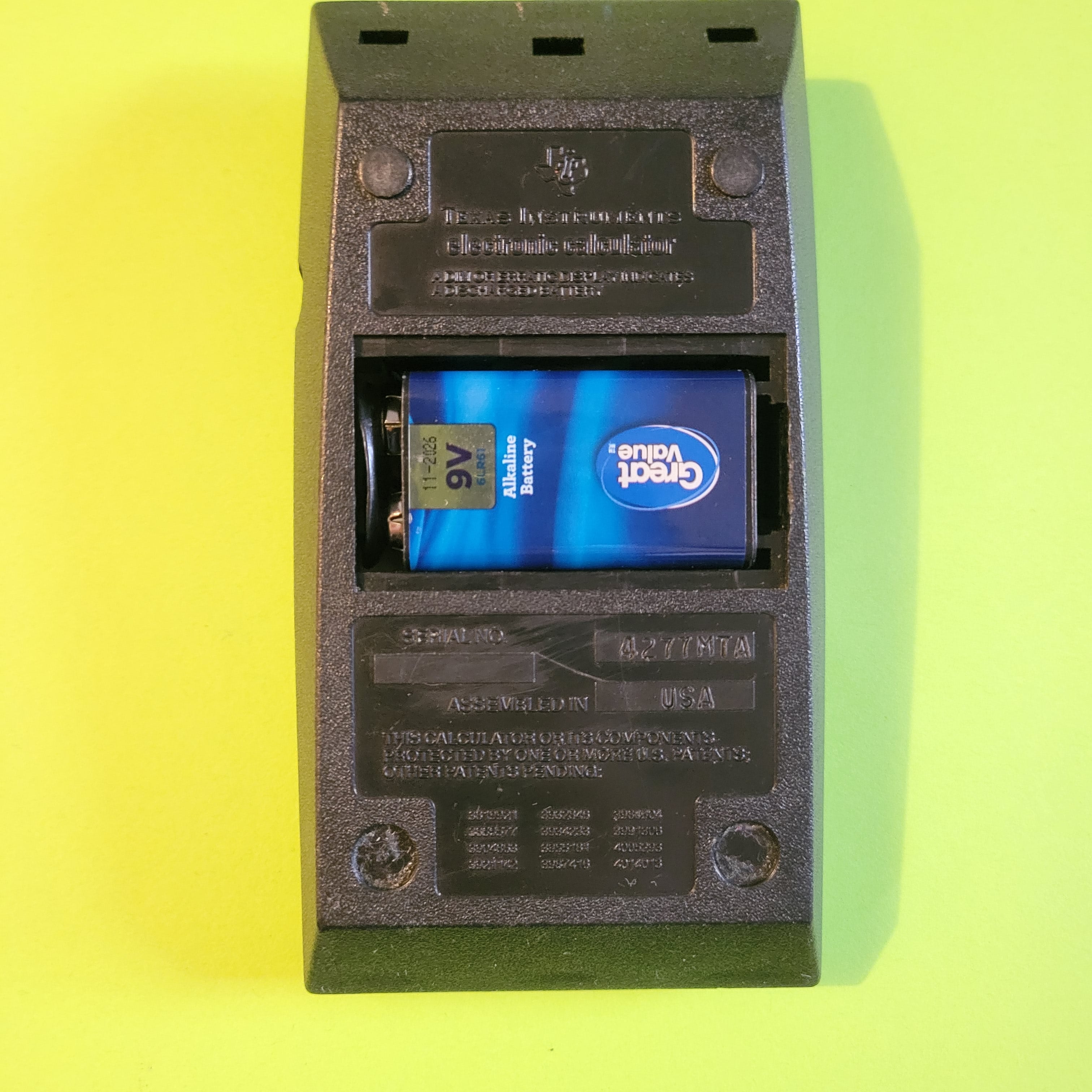 An image of the back of a Texas Instruments TI-1025 four function plus calculator